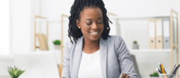 smiling black female employee working at desk